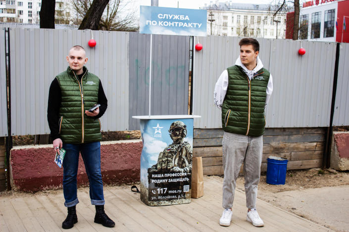 Two volunteers operate a mobile army recruitment information post set up on a crowded path near a train station in Moscow, Russia, April 13, 2023. / Credit: Vlad Karkov/SOPA Images/LightRocket/Getty
