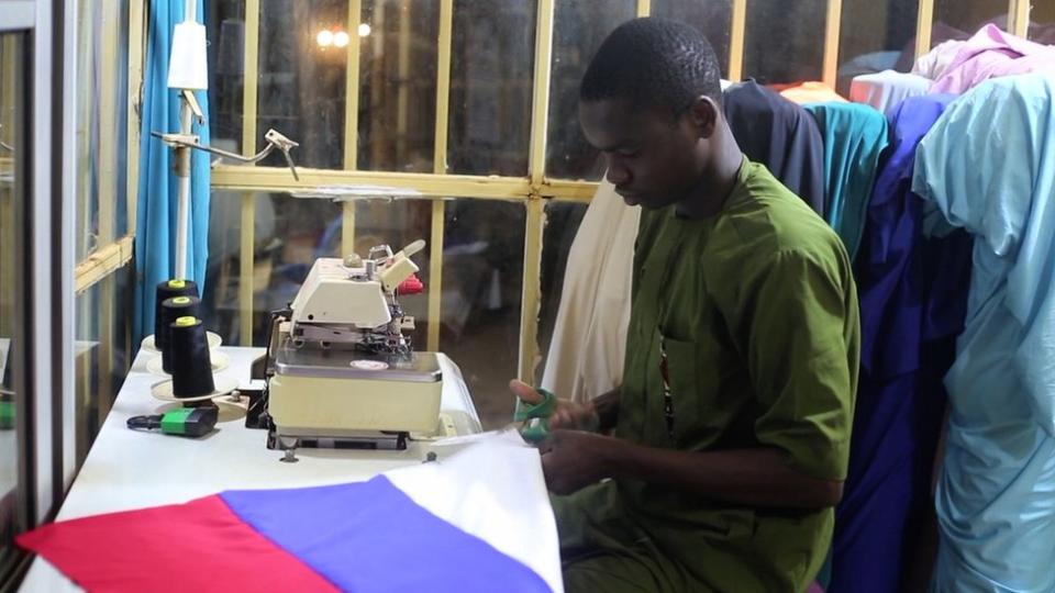 Tailor sewing Russian flag
