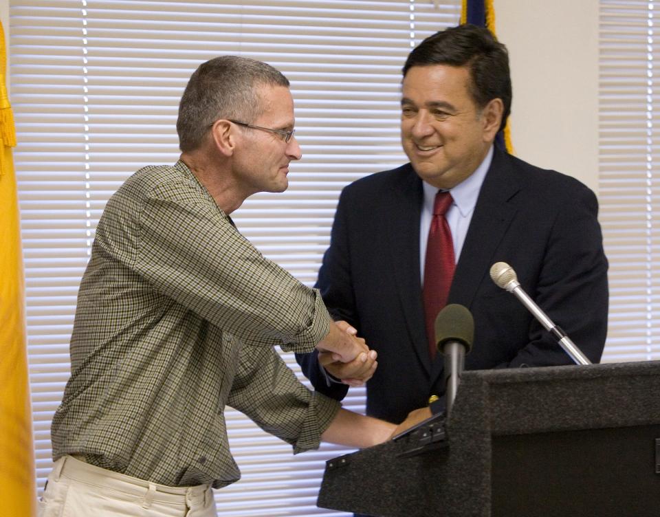 Chicago Tribune journalist Paul Salopek, left, and  N.M. Gov. Bill Richardson shake hands following a press conference in Albuquerque, N.M., on Sunday, Sept. 10, 2006, after their arrival in the United States following Salopek's release from a prison in the war-torn Darfur region. Richardson flew to Sudan on Friday to seek Salopek's release. 