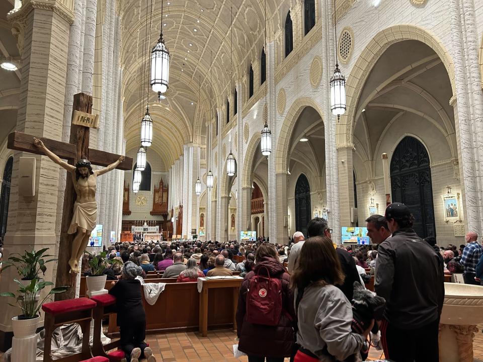 Inside the basilica during Lewiston’s first major vigil for the shooting victims (Andrea Blanco / The Independent)