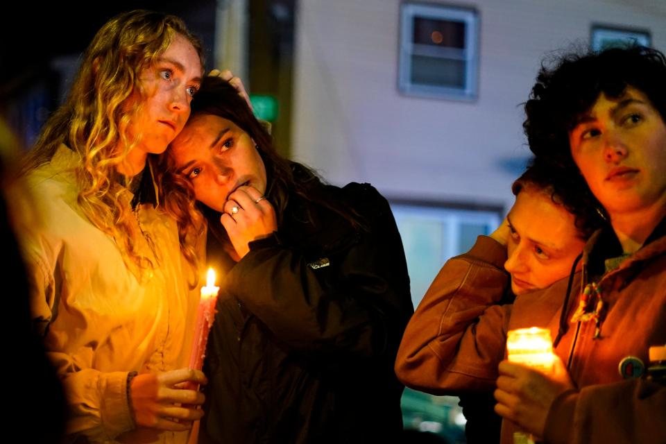People linger after a vigil for the victims of Wednesday's mass shootings, Sunday, Oct. 29, 2023, outside the Basilica of Saints Peter and Paul in Lewiston, Maine (AP)