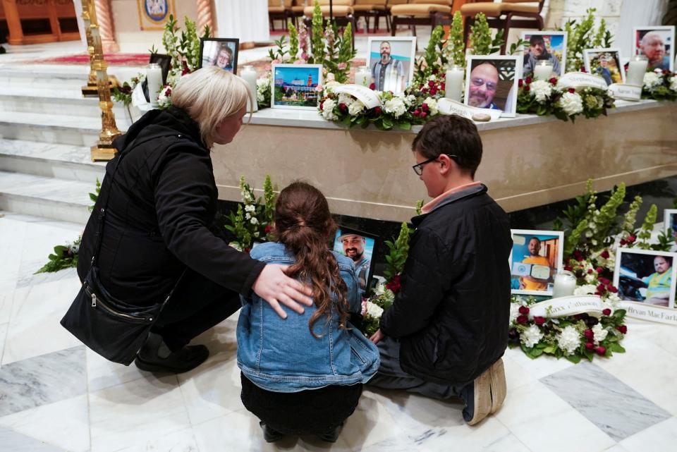 Mourners look at pictures of the victims during a vigil for the victims of the deadly mass shooting, at the Basilica of Saints Peter and Paul, in Lewiston, Maine, U.S., October 29, 2023 (REUTERS)