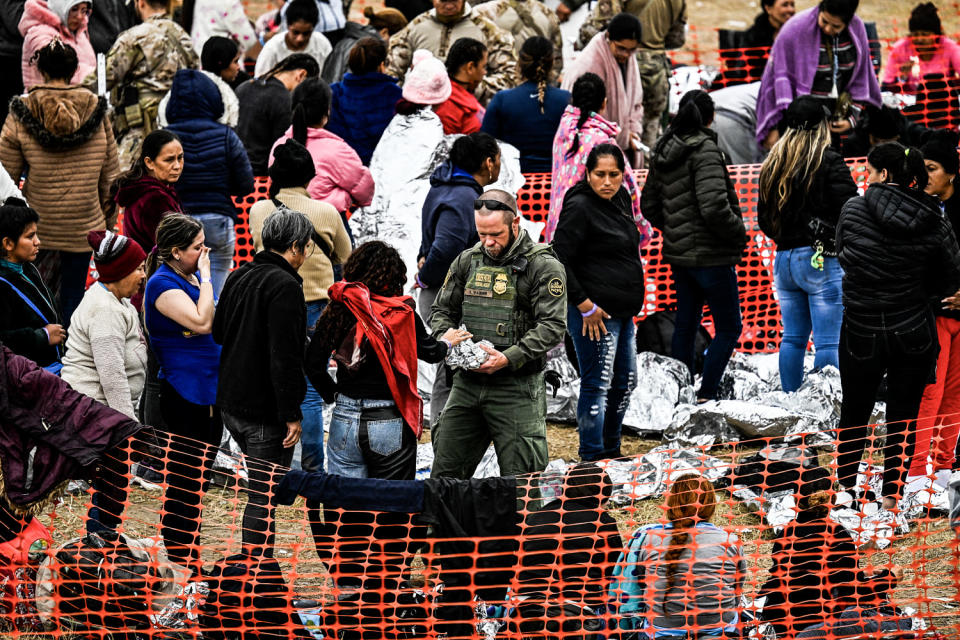 Immigrants waiting to be processed at a US Border Patrol transit center, after crossing the border from Mexico at Eagle Pass, Texas on Dec. 22, 2023. (Chandan Khanna / AFP via Getty Images)