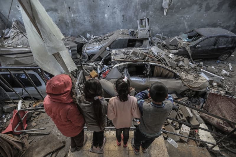 Palestinian children look on as they stand by rubble and debris of destroyed houses and vehicles in the aftermath of an Israeli bombardment, amid the ongoing battles between Israel and the Palestinian militant group Hamas. Mohammed Talatene/dpa