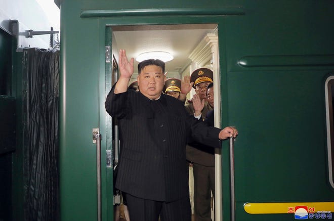 In this photo provided by the North Korean government, North Korea leader Kim Jong Un waves from a train in Pyongyang, North Korea, on Sept. 10, 2023, as he leaves for Russia.